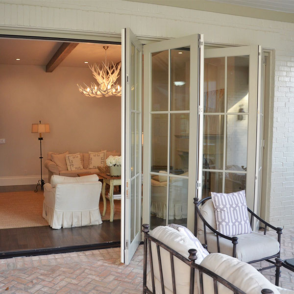 Bi-fold glass doors opened between indoor and outdoor spaces 