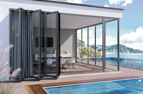Glass bi-fold patio doors with unobstructed view of mountain in foreground pened to reveal an ultra modern kitchen