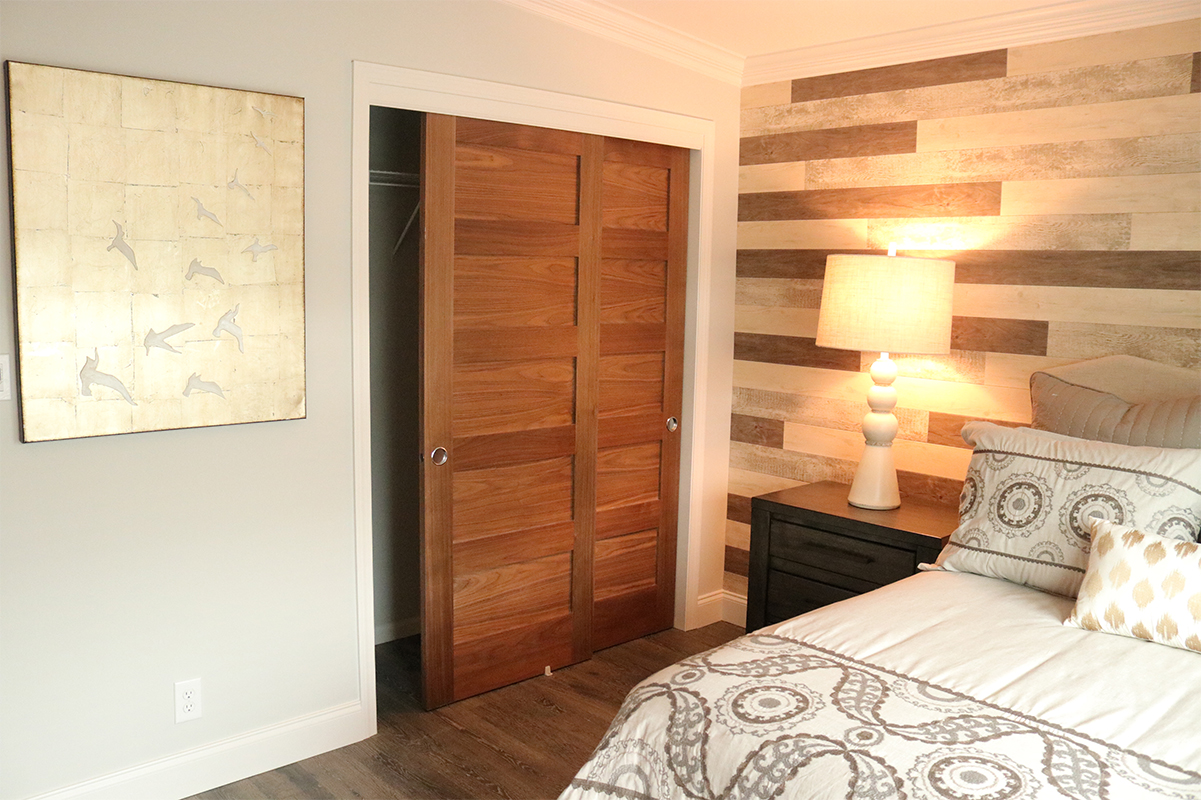 Custom wood interior shaker closet with sliding doors installed in classic bedroom