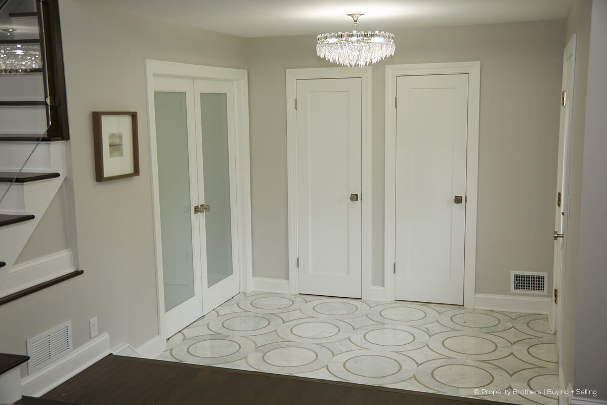 Modern looking white interior french doors with two matching doors on the peripheral wall