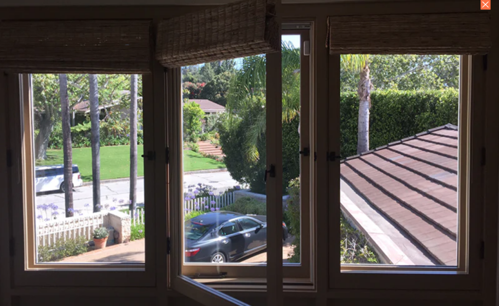 Three vinyl casement windows overlooking treed neighborhood in suburban neighborhood