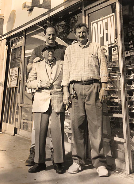 Sepia picture of Kenny Tashman with Grandpa Charles Tashman and my Father, Mark Tashman outside our Santa Monica Blvd store.
