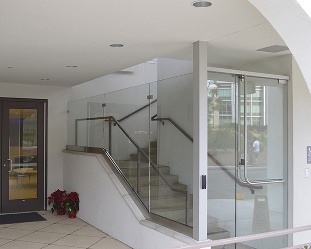 Glass and mirror combine making an attractive entrance to an office building and stairway