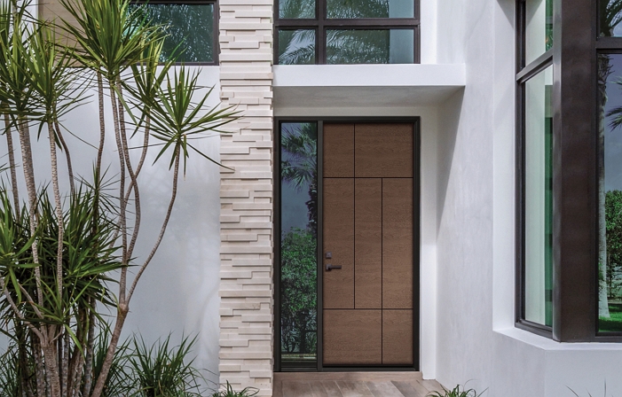 Fiberglass entry door with glass surround enhances the look of this modern home.