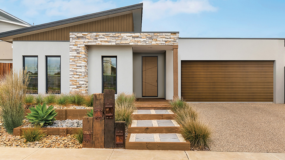 Modernistic home set in desert community sports an attractive front fiberglass entry door.