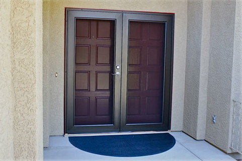 Security Alarm screens front double fiberglass entry doors with welcome mat.
