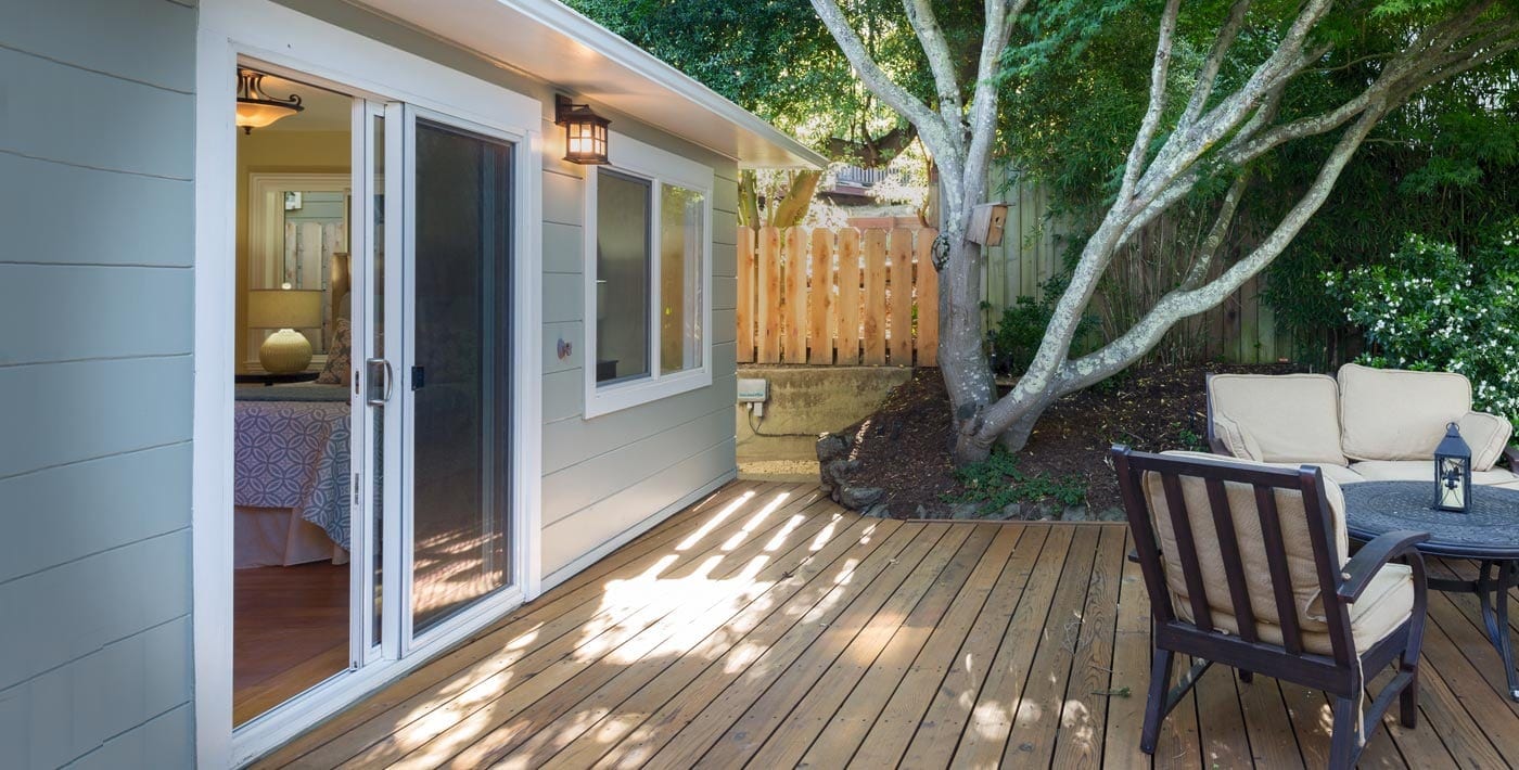 Backyard patio with Sliding Screen Doors providing entry to home family room