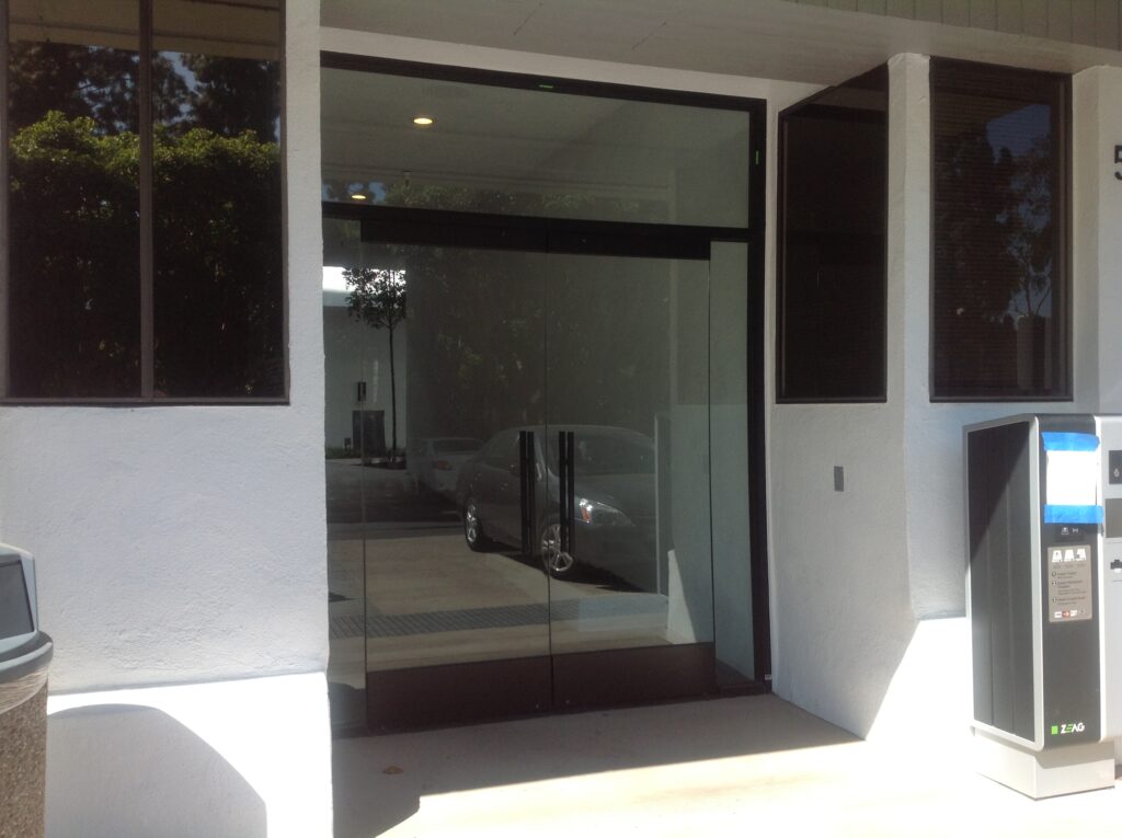 Modern glass storefront doors at a commercial building.