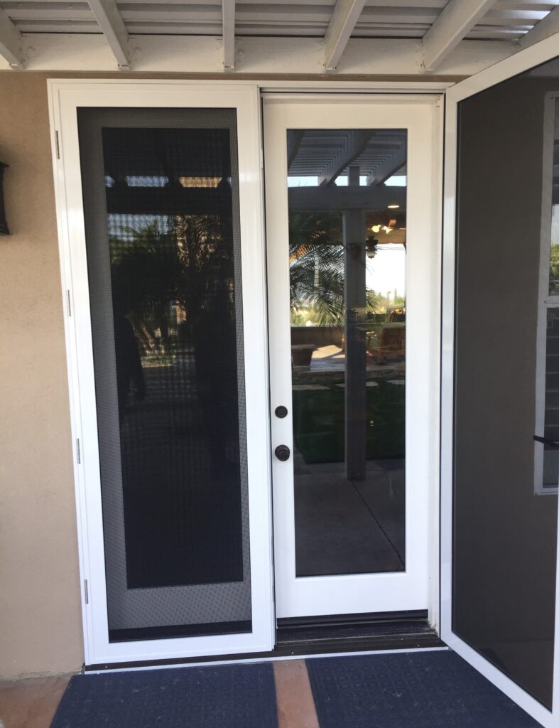 White double doors with full-length black screens opening to a patio.