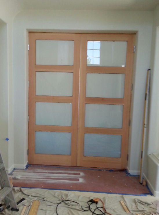 Wooden double doors with frosted glass panels.