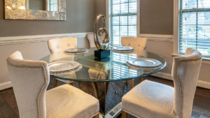 Elegant dining room featuring a round glass tabletop set for four.