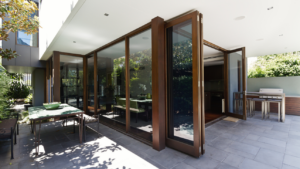 Modern bi-fold doors connecting outdoor patio to stylish kitchen in Los Angeles home