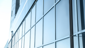 Exterior view of a commercial building with reflective tinted glass windows, highlighting solar control and energy efficiency.