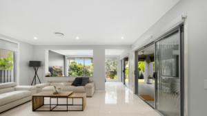 Modern living room with large, weatherproof doors and windows designed for all-season comfort and energy efficiency.