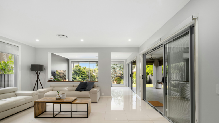 Modern living room with large, weatherproof doors and windows designed for all-season comfort and energy efficiency.